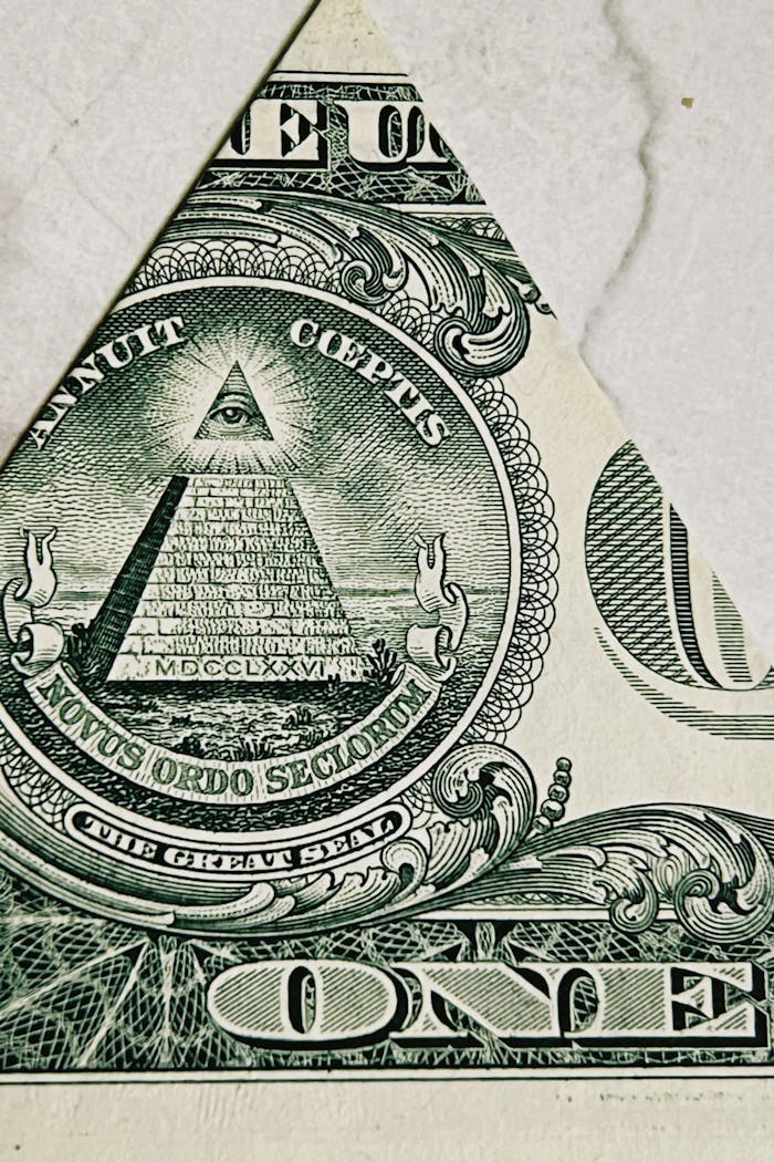 Macro shot of the pyramid and eye on a US dollar bill, symbolizing mystery and prosperity.